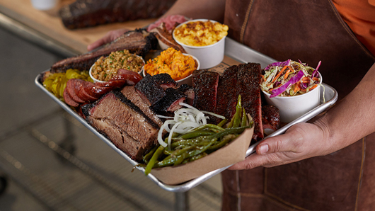 A platter of BBQ and sides