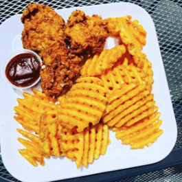A plate of vegan chicken nuggets and waffle fries at Pure Juicery Bar
