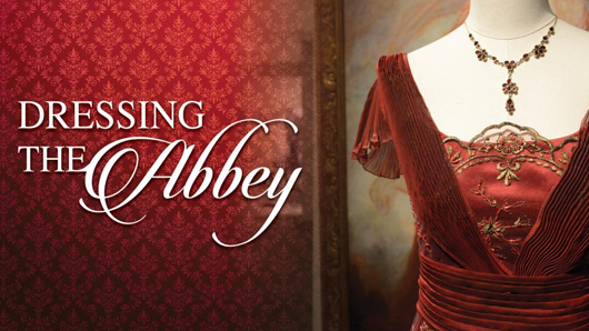 Dressing the Abbey exhibit graphic with a red dress adjacent