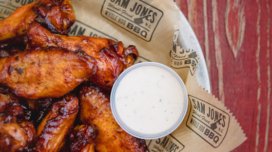 Sam Jones BBQ wings with a side of ranch dressing