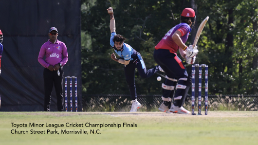 Photo of a man pitching in a game of cricket at the Toyota Minor League Cricket Championship Finals at Church Street Park in Morrisville, N.C.