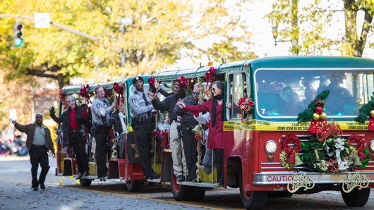 A festively decorated tram cruising along in the Raleigh Christmas Parade