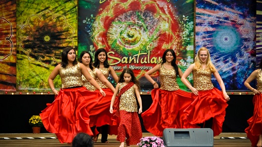 A group of women dancing on a stage at the Cary Diwali festival
