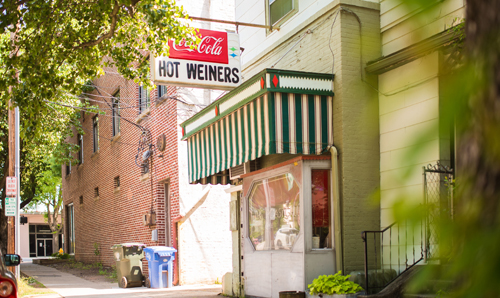 Exterior of The Roast Grill, with a vintage Coca-Cola and Hot Weiners sign