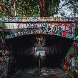A tunnel covered in colorful grafitti