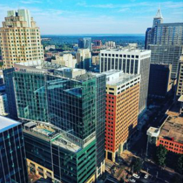 A photo taken above several buildings in the downtown Raleigh skyline