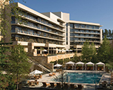 Exterior of The Umstead Hotel and Spa, with a pool in the foreground