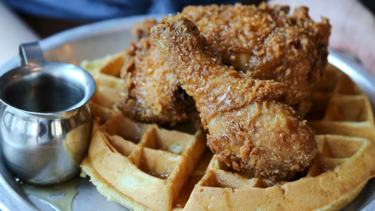 A delicious-looking plate of chicken and waffles with syrup