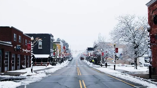 A snowy photo of downtown Apex looking down the center of N. Salem St.